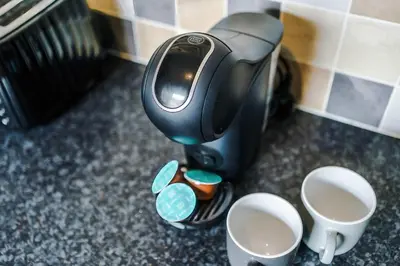 a coffee maker on a counter with three cups of coffee at St Helens Central, 2 Bed , Long Stay OFFERS, Contractors, Relocations, Families, Sleeps 4 Banner Street 10, St Helens in Saint Helens