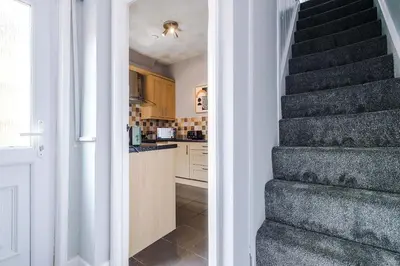 a stairway leading to a kitchen with a staircase at St Helens Central, 2 Bed , Long Stay OFFERS, Contractors, Relocations, Families, Sleeps 4 Banner Street 10, St Helens in Saint Helens