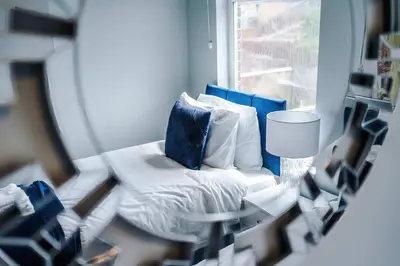 a room with a bed with pillows and a window at St Helens Central, 2 Bed , Long Stay OFFERS, Contractors, Relocations, Families, Sleeps 4 Banner Street 10, St Helens in Saint Helens