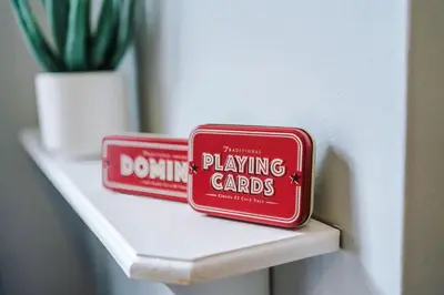 two domino gambling cards sitting on a shelf at St Helens Central, 2 Bed , Long Stay OFFERS, Contractors, Relocations, Families, Sleeps 4 Banner Street 10, St Helens in Saint Helens