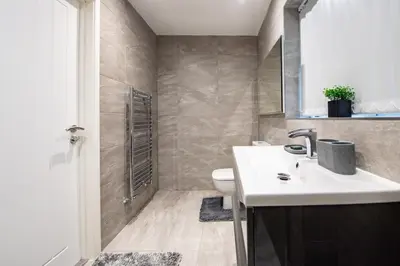a bathroom with a sink and a toilet at Superb Location Stunning Luxury 4 Bedroom House in Liverpool