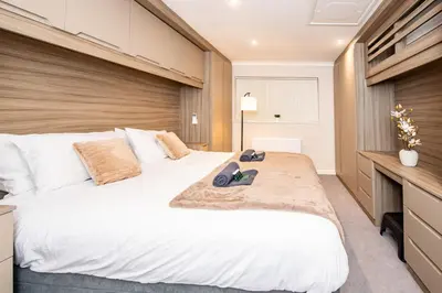 a bedroom with a large bed and a desk at Superb Location Stunning Luxury 4 Bedroom House in Liverpool