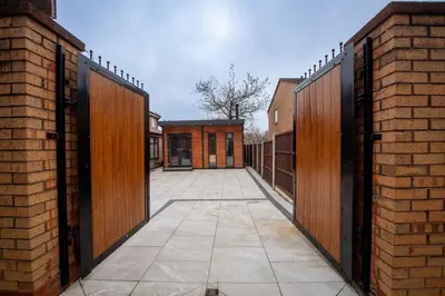 an open gate of a building with a brick wall at Superb Location Stunning Luxury 4 Bedroom House in Liverpool