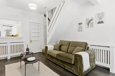 a living room with a couch and a table at Warm and Cosy Home at L6 Sleeps 5 in Liverpool