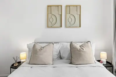 a bedroom with a white bed with two lamps at Warm and Cosy Home at L6 Sleeps 5 in Liverpool