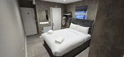 a bedroom with a bed with white sheets and pillows at Cozy 1 bed apartment Blackpool in Blackpool