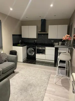 a living room with a couch and a kitchen at Cozy 1 bed apartment Blackpool in Blackpool