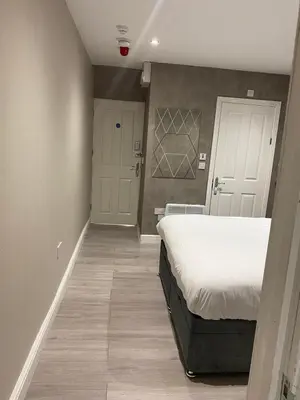a bedroom with a bed and a hallway with a door at Cozy 1 bed apartment Blackpool in Blackpool