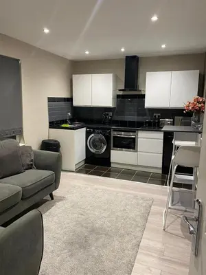 a living room with a couch and a kitchen at Cozy 1 bed apartment Blackpool in Blackpool