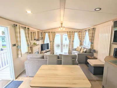 a living room with a couch and a table at Carol & Nick's holiday home in Heysham