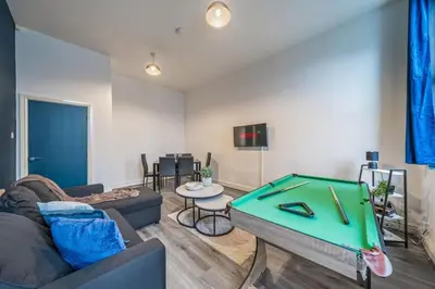 a living room with a couch and a pool table at Spacious City Flat - 2 Bedrooms - Sleeps 7 in Liverpool