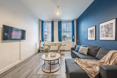 a living room with a couch and a table at Spacious City Flat - 2 Bedrooms - Sleeps 7 in Liverpool