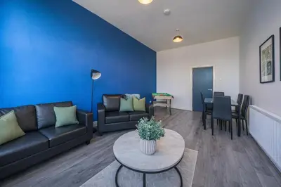 a living room with a couch and a table at Comfortable 2BR Flat - Sleeps 6 - Ideal City Stays in Liverpool