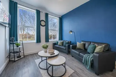 a living room with a couch and a table at Comfortable 2BR Flat - Sleeps 6 - Ideal City Stays in Liverpool