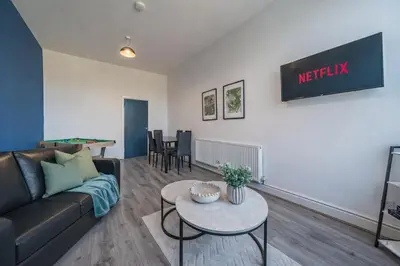 a living room with a couch and a table at Comfortable 2BR Flat - Sleeps 6 - Ideal City Stays in Liverpool