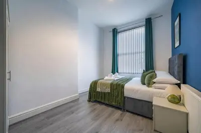 a bedroom with a bed and a window in it at Comfortable 2BR Flat - Sleeps 6 - Ideal City Stays in Liverpool