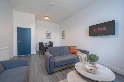 a living room with a couch and a table at Large 2-Bedroom Flat Sleeps 7 - Perfect for Groups in Liverpool