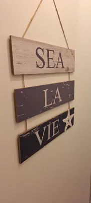 two signs hanging on a wall with the words sea lease at King's Haven in Southport