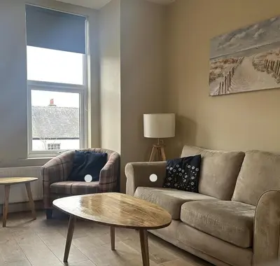 a living room with a couch and a table at King's Haven in Southport