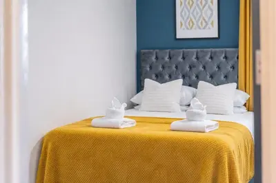 a bed with two towels on top of it at 2BR Flat - 4 Beds Sleeps 7 - Trinity Vaults in Liverpool