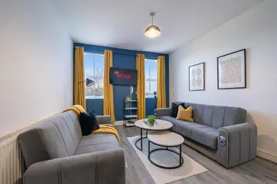 a living room with a couch and a table at 2BR Flat - 4 Beds Sleeps 7 - Trinity Vaults in Liverpool