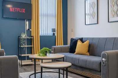 a living room with a couch and a table at 2BR Flat - 4 Beds Sleeps 7 - Trinity Vaults in Liverpool