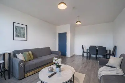 a living room with a couch and a table at Family-Friendly 2BR Flat - Sleeps 7 in Liverpool
