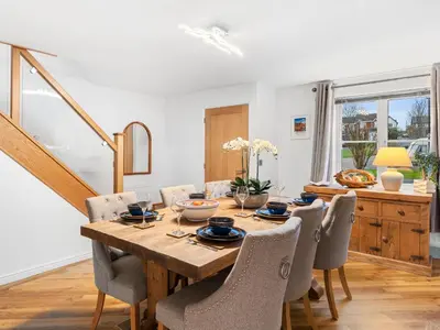 a dining room with a wooden table and chairs at Central Chorley Home Free Parking Fast Wi-Fi in Chorley