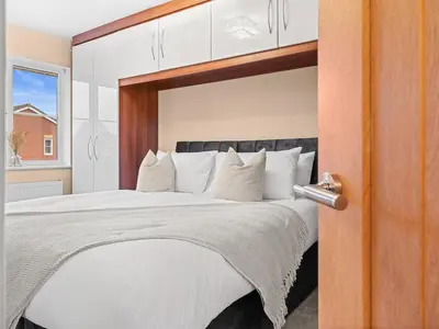 a bedroom with a large bed with white pillows at Central Chorley Home Free Parking Fast Wi-Fi in Chorley