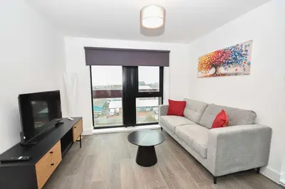 a living room with a couch and a tv at Spacious 2 Bed Apartment in Central Liverpool in Liverpool