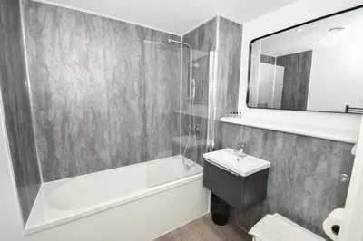 a bathroom with a shower tub and a sink at Spacious 2 Bed Apartment in Central Liverpool in Liverpool