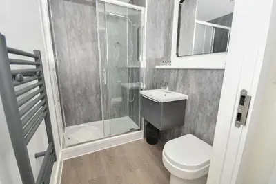 a small bathroom with a shower and a toilet at Spacious 2 Bed Apartment in Central Liverpool in Liverpool