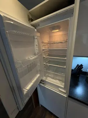 an empty refrigerator with its door open in a kitchen at City View Studio Apartment Liverpool by StaySavvy Accommodation in Liverpool