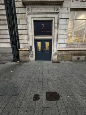 a building with a door with the number seven on it at City View Studio Apartment Liverpool by StaySavvy Accommodation in Liverpool