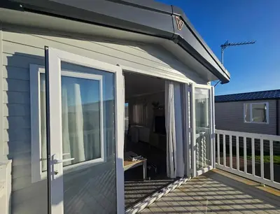 an open sliding glass door on a deck at Crozzer's Place in Heysham