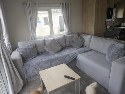 a living room with a couch and a table at Crozzer's Place in Heysham