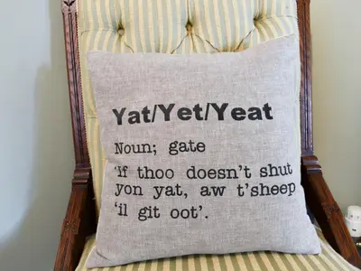 a pillow on a bed with a sign on it at Yan Cottage - Uk43540 in Spark Bridge