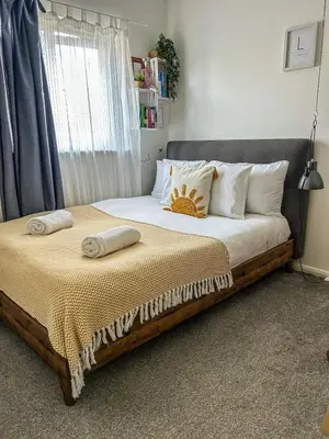 a bed with two pillows on it in a bedroom at Preloved stylish home Wi-Fi Double driveway in Kirkby