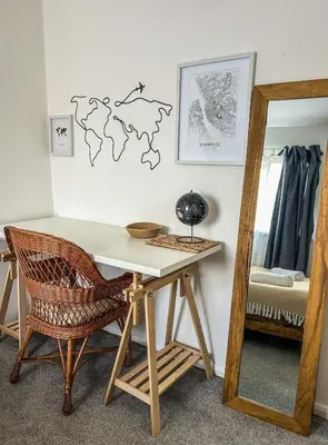 a desk with a chair and a mirror in a room at Preloved stylish home Wi-Fi Double driveway in Kirkby
