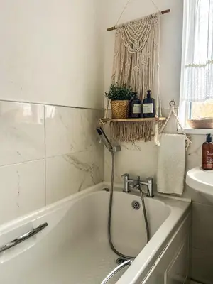 a bathroom with a bath tub and a sink at Preloved stylish home Wi-Fi Double driveway in Kirkby