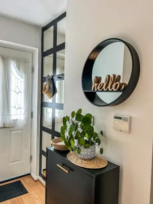 a mirror on a wall with a plant on a dresser at Preloved stylish home Wi-Fi Double driveway in Kirkby