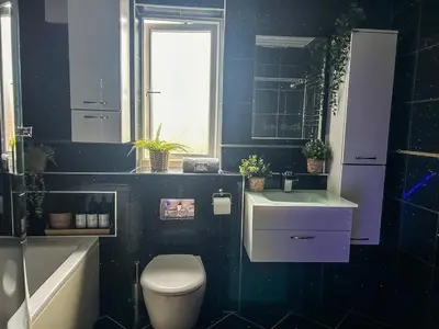 a bathroom with a toilet and a sink and a window at Homely house Free parking WIFI Close to centre&anfield in Liverpool