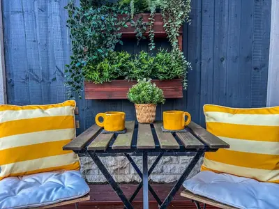 a table with two yellow chairs and two mugs on it at Homely house Free parking WIFI Close to centre&anfield in Liverpool
