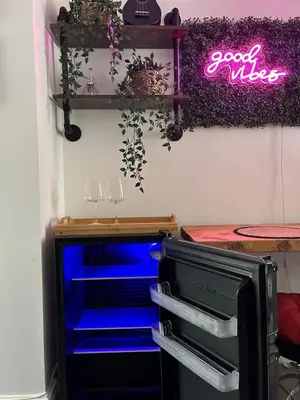 a desk with blue drawers and a neon sign at Music touch house Free Parking WIFI Close to Anfield stadium in Liverpool