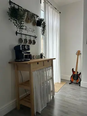 a kitchen with a table and a guitar in a room at Music touch house Free Parking WIFI Close to Anfield stadium in Liverpool