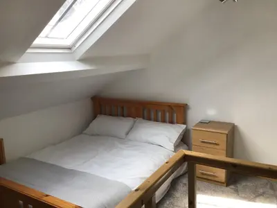 a small bedroom with a bed and a window at Tastefully Renovated Cottage in Ulverston in Ulverston