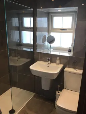 a bathroom with a sink and a toilet and a shower at Tastefully Renovated Cottage in Ulverston in Ulverston