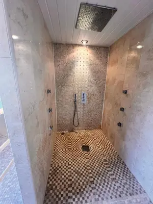 a bathroom with a shower with a tiled floor at Casa del Mare-Beachfront House in Morecambe