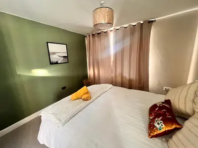 a bedroom with a bed with a stuffed animal on it at Casa del Mare-Beachfront House in Morecambe