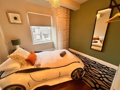 a bedroom with a bed with a car on it at Casa del Mare-Beachfront House in Morecambe